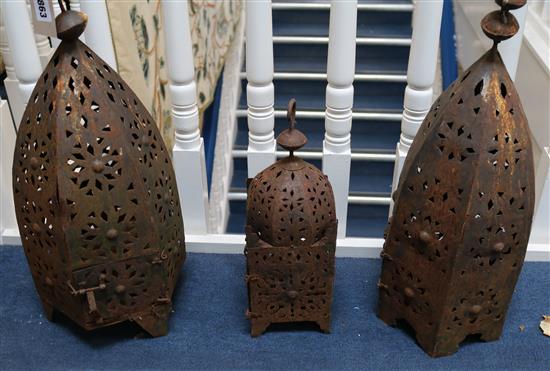 Three pierced metal lanterns